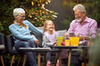 © luckybusiness - grandparents laughing out loud with their granddaughter, having wonderful time