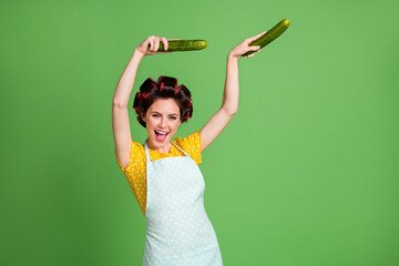 Sticker - Photo of crazy positive vintage girl cook veggie eco dish meal dance dancer cucumber wear yellow dotted dress skirt hair rollers isolated over green color background