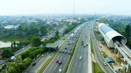 Wall Mural - Traffic on toll road with unoperated new LRT train