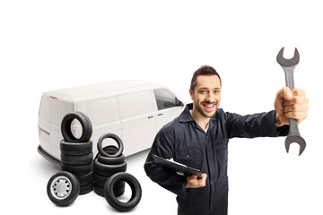 Wall Mural - Auto mechanic worker with a white van holding a key wrench tool