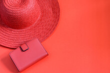 Lady's Summer Red Straw Hat And Purse On The Red Background, Isolated.