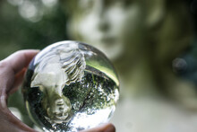 Glass Orb Reflecting Statue Reflection