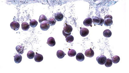 Wall Mural - Fresh figs falling into the water isolated on white background. Food photography.