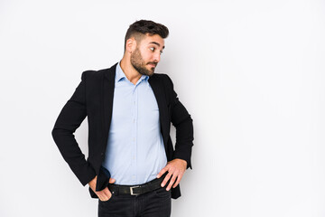 Young caucasian business man against a white background isolated touching back of head, thinking and making a choice.
