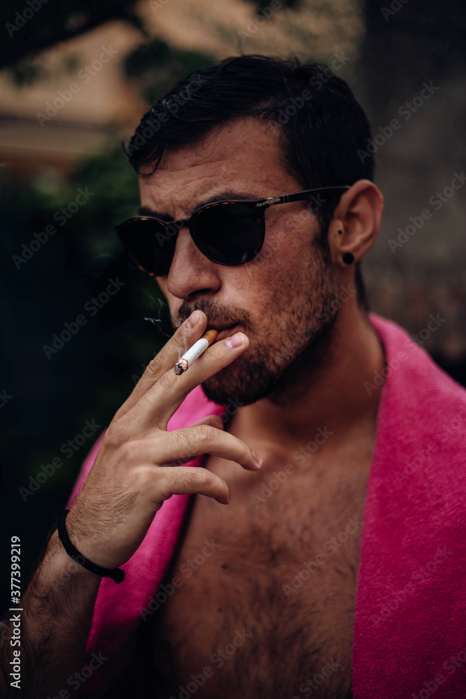 Guy with sunglasses and a cigarette in his mouth. Stock Photo