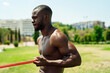 © Cavan Images - young athlete doing biceps exercise with rubber bands