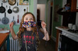 © Cavan Images - Young Girl asking for help putting on her mask