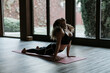 © JAVIER PARDINA/Stocksy - Hispanic woman training yoga in her studio.