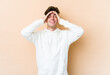 © Asier - Young caucasian man isolated on beige background laughs joyfully keeping hands on head. Happiness concept.