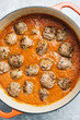 © CWP, LLC/Stocksy - Meatballs added to fresh marinara sauce