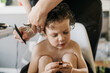 © CWP, LLC/Stocksy - Preschool age boy having his hair cut by his mother