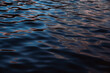 © Robert Kohlhuber/Stocksy - Dark reflections on water surface of lake