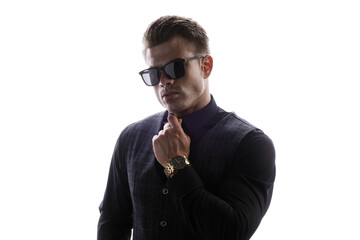 Wall Mural - Portrait of beautyful guy on white background. High fashion model posing in studio. Attractive man in classic suit and sunglasses.