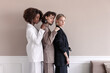 © Viktor Solomin/Stocksy - A small group of fashion multiracial multiethnic young beautiful sensual models are posing near the wall in studio room. Togetherness.