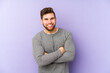 © Asier - Young caucasian man isolated on purple background laughing and having fun.