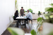 © Claire Bonnor/Austockphoto - Three people collaborating in an open office