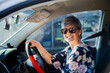 © Clare Seibel-Barnes/Austockphoto - Happy middle aged driver in car with sunnies on