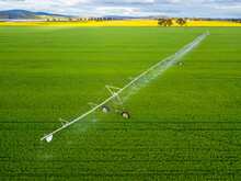 Looking Down On A Large Irrigation Sprinkler In A Green Paddock