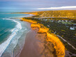 © Gary Chapman/Austockphoto - Looking down on a walking track along a cliff top over waves breaking on a beach