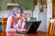 © Clare Seibel-Barnes/Austockphoto - Middle aged woman using online banking from her laptop