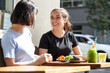 © Jonah Ritchie/Austockphoto - Female friends sitting outdoors at cafe in sunshine