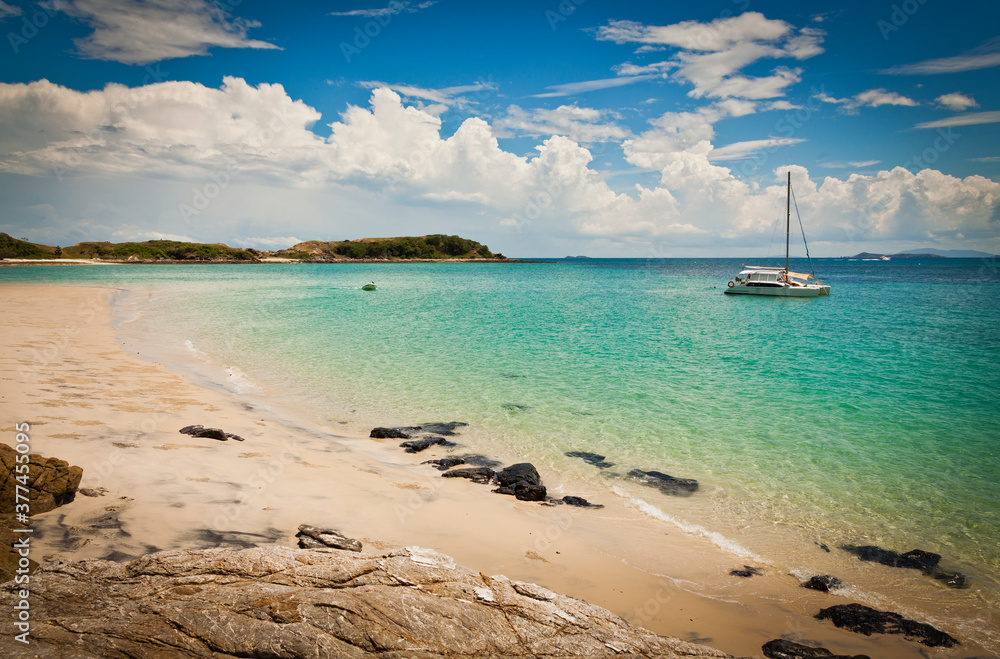 Ideal beach on Keppel Island, Queensland, Australia. Sun-soaked sand beside the turquoise ocean at the start of the Great Barrier Reef.