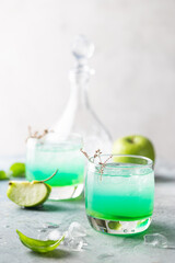 Wall Mural - Green cocktail with apples on white background, martini cocktail in glasses