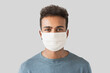 © kite_rin - Portrait of a young man wearing protective face mask, Masked men studio portrait isolated on gray background, Epidemic, pandemic, corona virus protection, healthy lifestyle, people concept