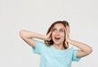© golubovy - Surprised woman. Special offer. Portrait of excited overwhelmed lady in blue looking at empty space smiling touching head isolated on light. Commercial background. Sale discount.