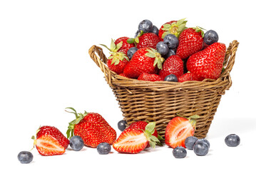 Wall Mural - Strawberries with blueberries and basket isolated on a white background.