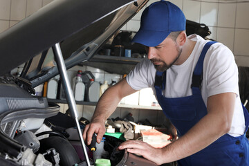 Poster - Professional auto mechanic fixing modern car in service center