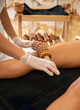 Madero therapy. Woman on anti cellulite massage treatment. Close up. Copy space. Female on the massage table next to her is wooden massage tools for Maderotherapy.