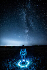 Wall Mural - lone figure standing under a starry sky