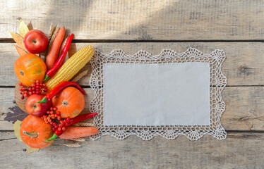 Autumn background set, fallen leaves, fruits, vegetables, wooden table. Seasonal side composition, aged vintage linen napkin, copy space. Thanksgiving food, healthy and fresh, top view, flat lay.