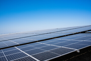 solar energy power plant is generating renewable energy. solar panels under blue sky.