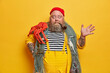 © wayhome.studio  - Surprised emotional seafarer smokes pipe and raised hand, stares bugged eyes at camera. Bearded boatswain poses with sea creature against vivid yellow background. Fisherman caught big red octopus