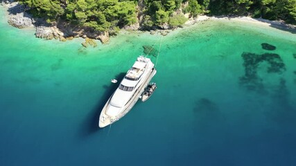 Wall Mural - Aerial drone video of luxury yacht anchored in tropical exotic island bay with turquoise sea