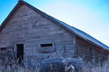 Old Barn In A Frost Covered Field.