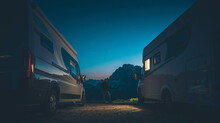 Alpine Camping Pitch And Men Between Two RVs Camper Vans