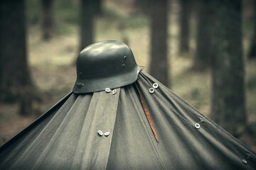 Military helmet of the Finnish army during the war on the Karelian isthmus, on top of a tent in the forest