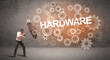 © ra2 studio - Businessman defending with umbrella from HARDWARE inscription, technology concept