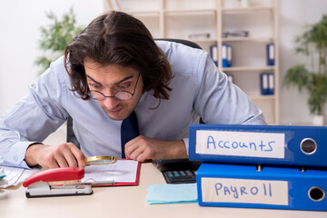 Young male financial manager in the office