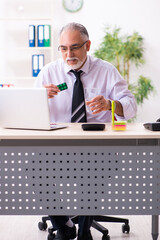 Wall Mural - Old sick employee suffering at workplace