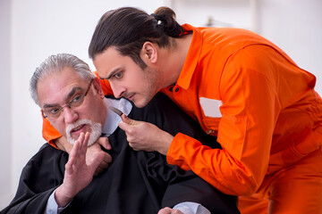 Old male judge meeting with young captive in courthouse