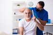 © Elnur - Old man visiting young male doctor in hair transplantation conce