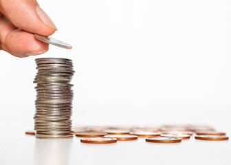 business man hand put silver coin stack growth up isolated on white background. money saving, financial growing, business startup, economy budget and investment concept.