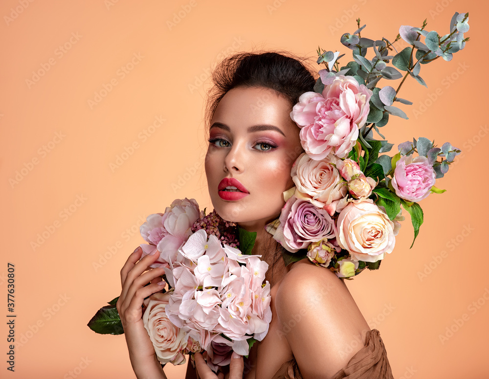Attractive brunette girl with big beautiful  bouquet of  flowers. Beautiful white girl with flowers.  Pretty woman with bright makeup. Art portrait with flowers. - obrazy, fototapety, plakaty 