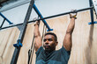 © Mego-studio - Athletic man doing pull up exercise at the gym.