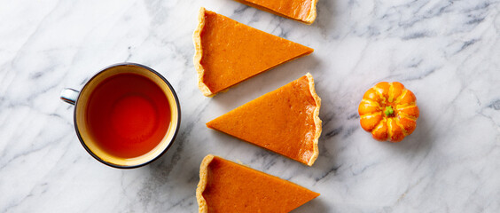 Wall Mural - Pumpkin pie, tart with cup of tea. Marble background. Top view.