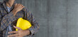 © anut21ng Stock - Construction worker shoulder pain on cement wall background with copy space
